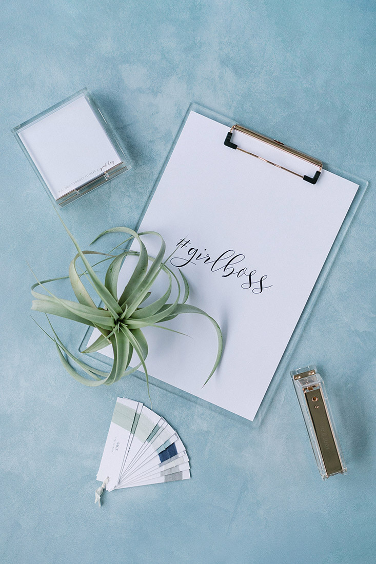 Photo of a stationery desk with a #girlboss hashtag written on a notepad